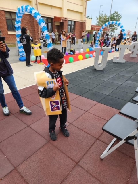 Jayce, a kindergarten student in Ms. Galamison’s kindergarten class, poses for pictures as eager parents snap shots of the young models at Humphreys West Elementary School