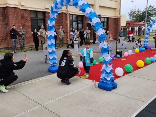 Students walk the red carpet to stand on the yellow mark where they strike poses for their adoring fans at Humphreys West Elementary School